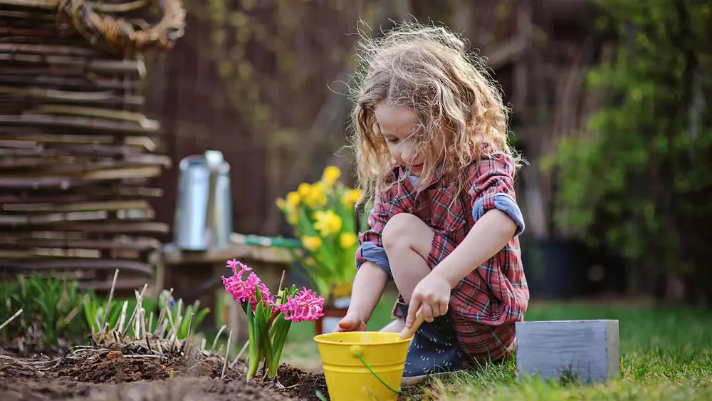 Illustration of a little girl planting a flower to make a difference.